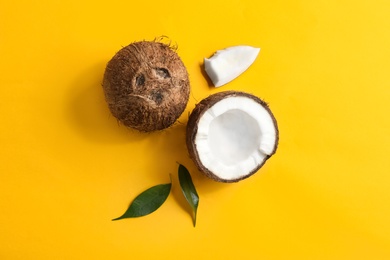 Flat lay composition with coconuts on color background