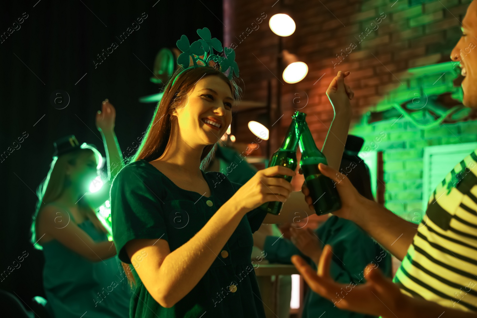 Photo of Couple with beer celebrating St Patrick's day in pub