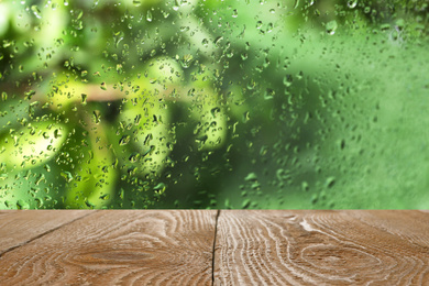 Image of Wooden table near window on rainy day