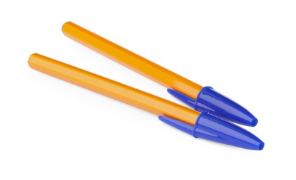 New orange plastic pens isolated on white