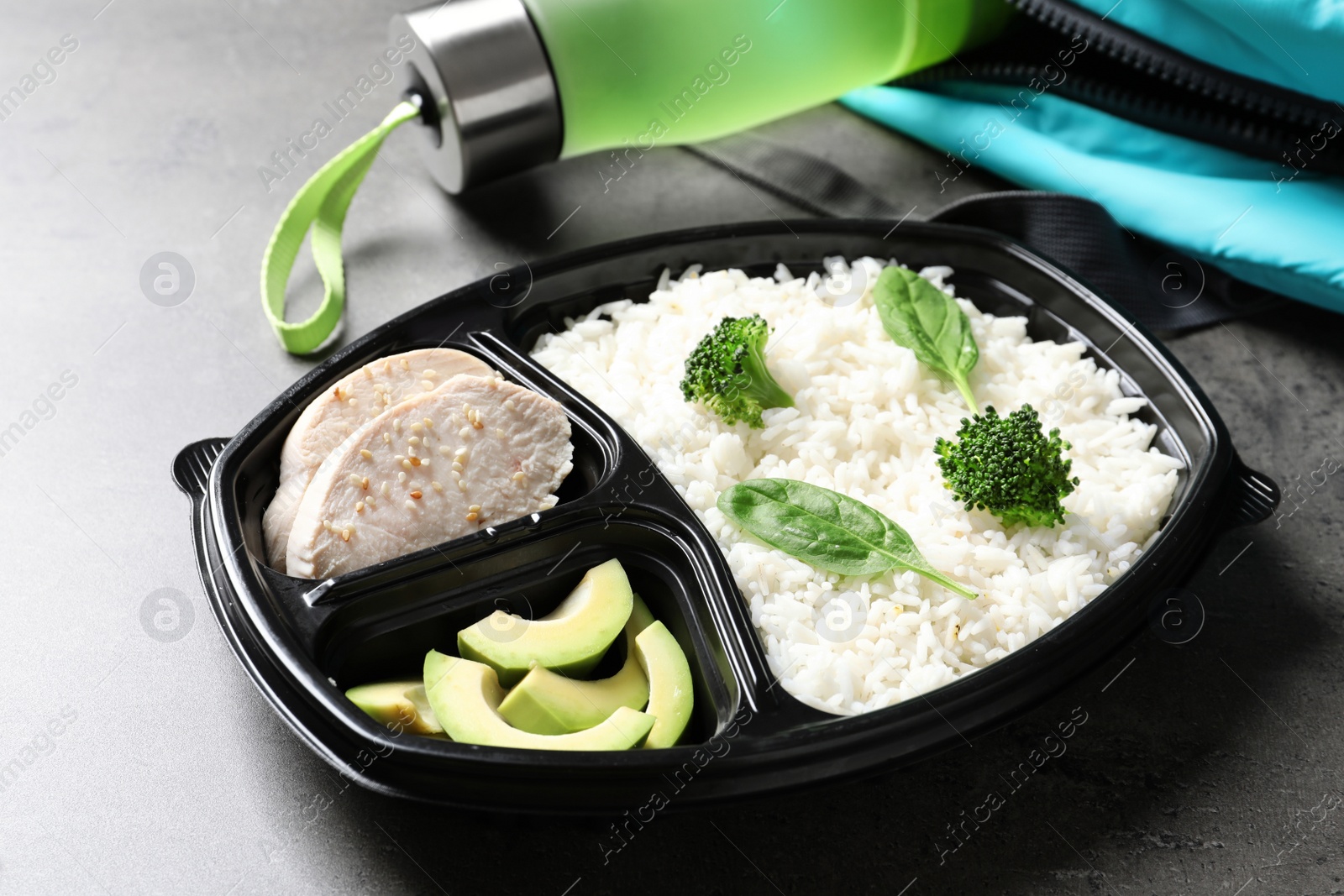 Photo of Container with natural protein food on gray table