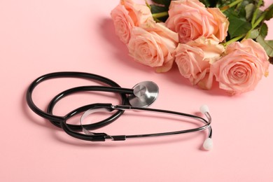 Photo of Stethoscope and flowers on pink background. Happy Doctor's Day