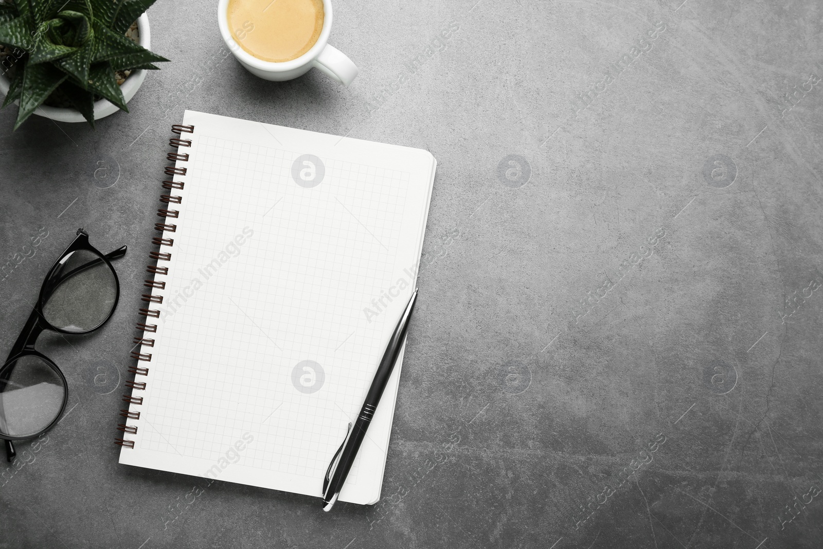 Photo of Flat lay composition with notebook on grey table