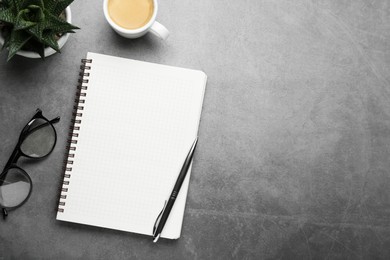 Flat lay composition with notebook on grey table