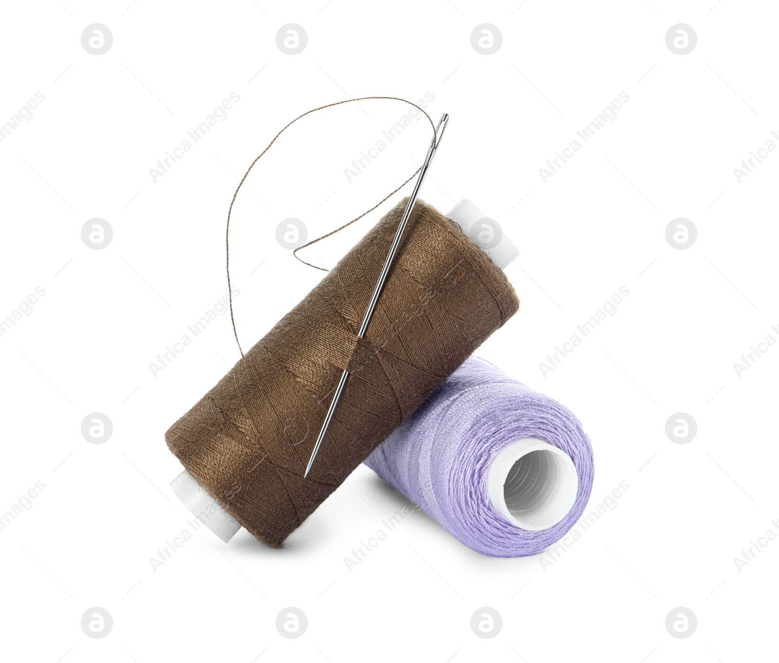 Photo of Different colorful sewing threads and needle on white background