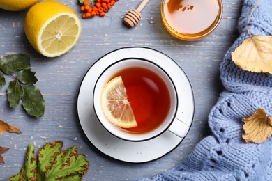 Photo of Flat lay composition with cup of hot drink on grey wooden table. Cozy autumn atmosphere