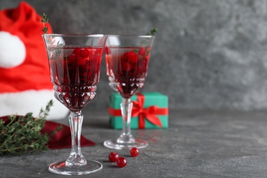 Delicious Christmas cocktail with liqueur on grey table. Space for text