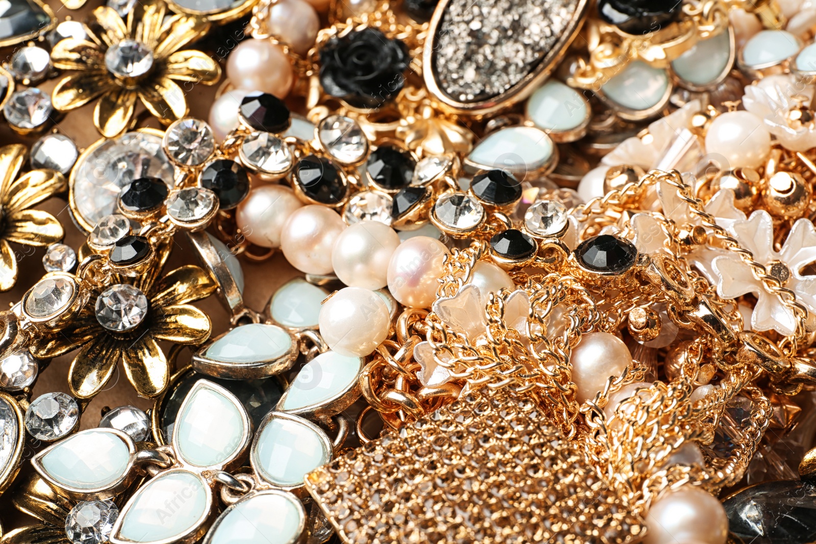 Photo of Different stylish jewelry as background, closeup view