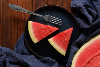 Sliced fresh juicy watermelon served on wooden table, flat lay