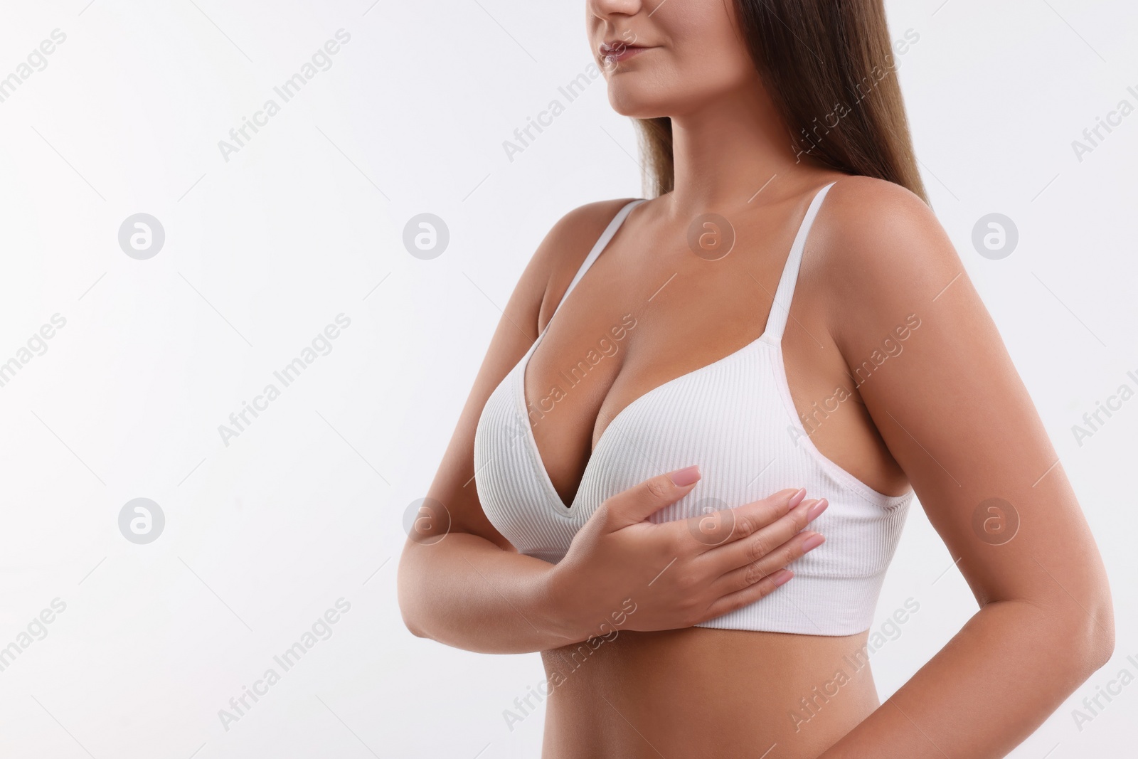 Photo of Woman with beautiful breast on white background, closeup. Space for text