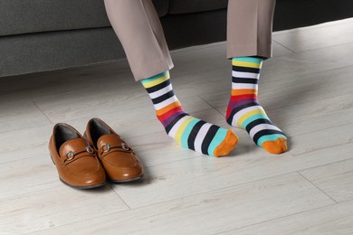 Photo of Man wearing colorful socks indoors, closeup view