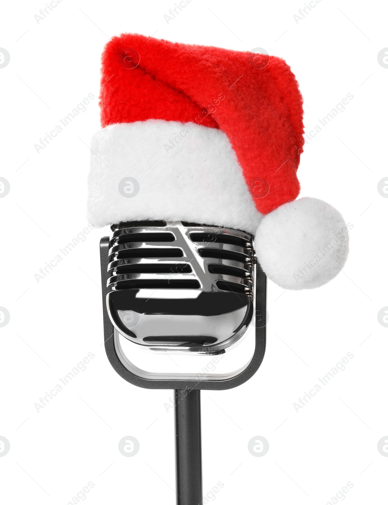 Photo of Retro microphone with Santa hat isolated on white. Christmas music