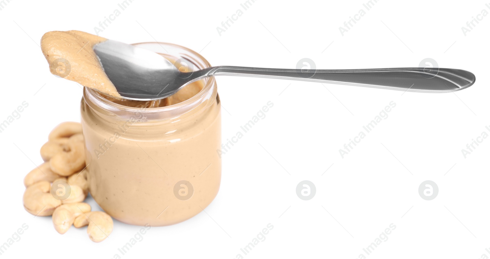 Photo of Tasty nut paste in jar, spoon and cashews isolated on white