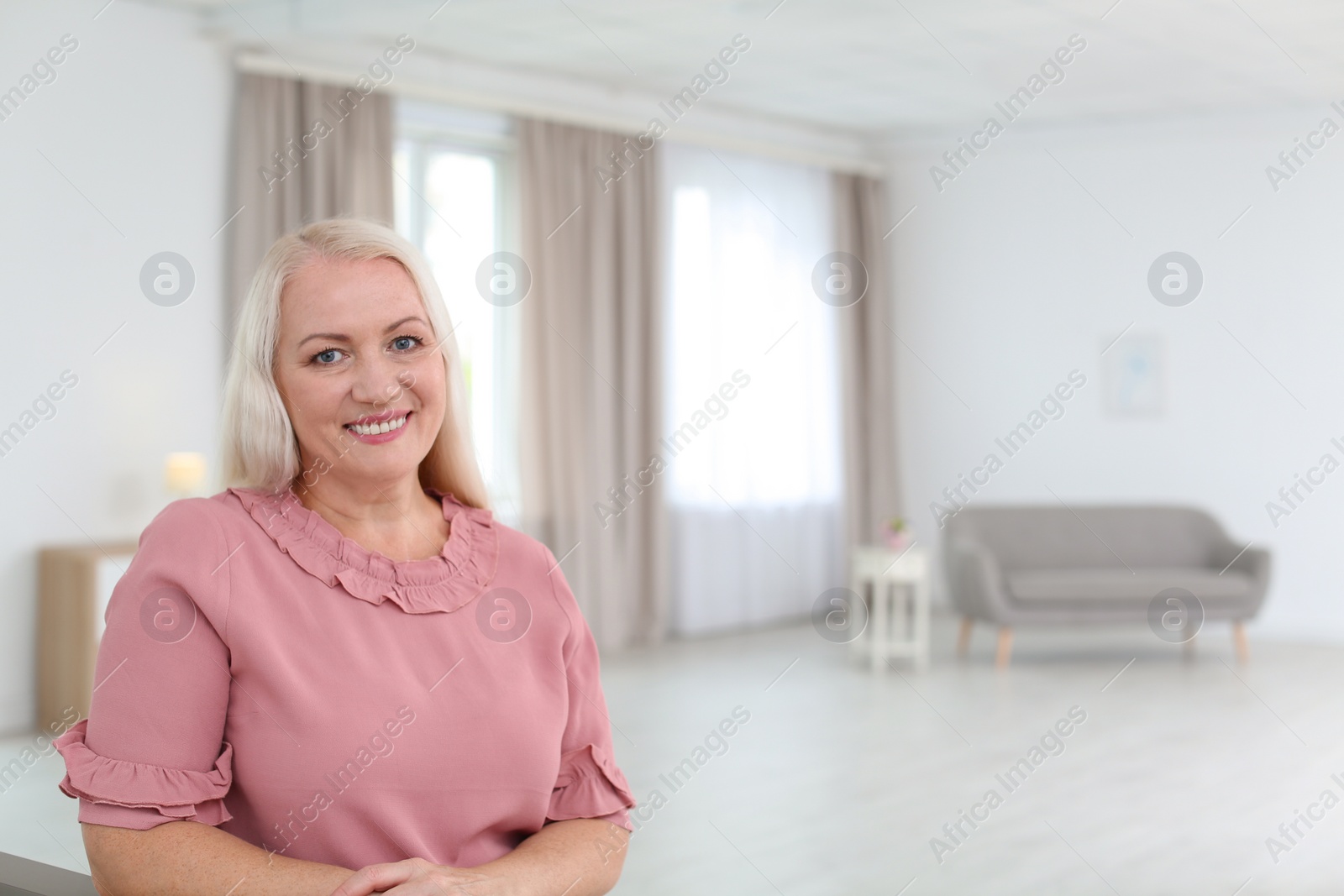 Photo of Portrait of beautiful older woman against blurred background with space for text