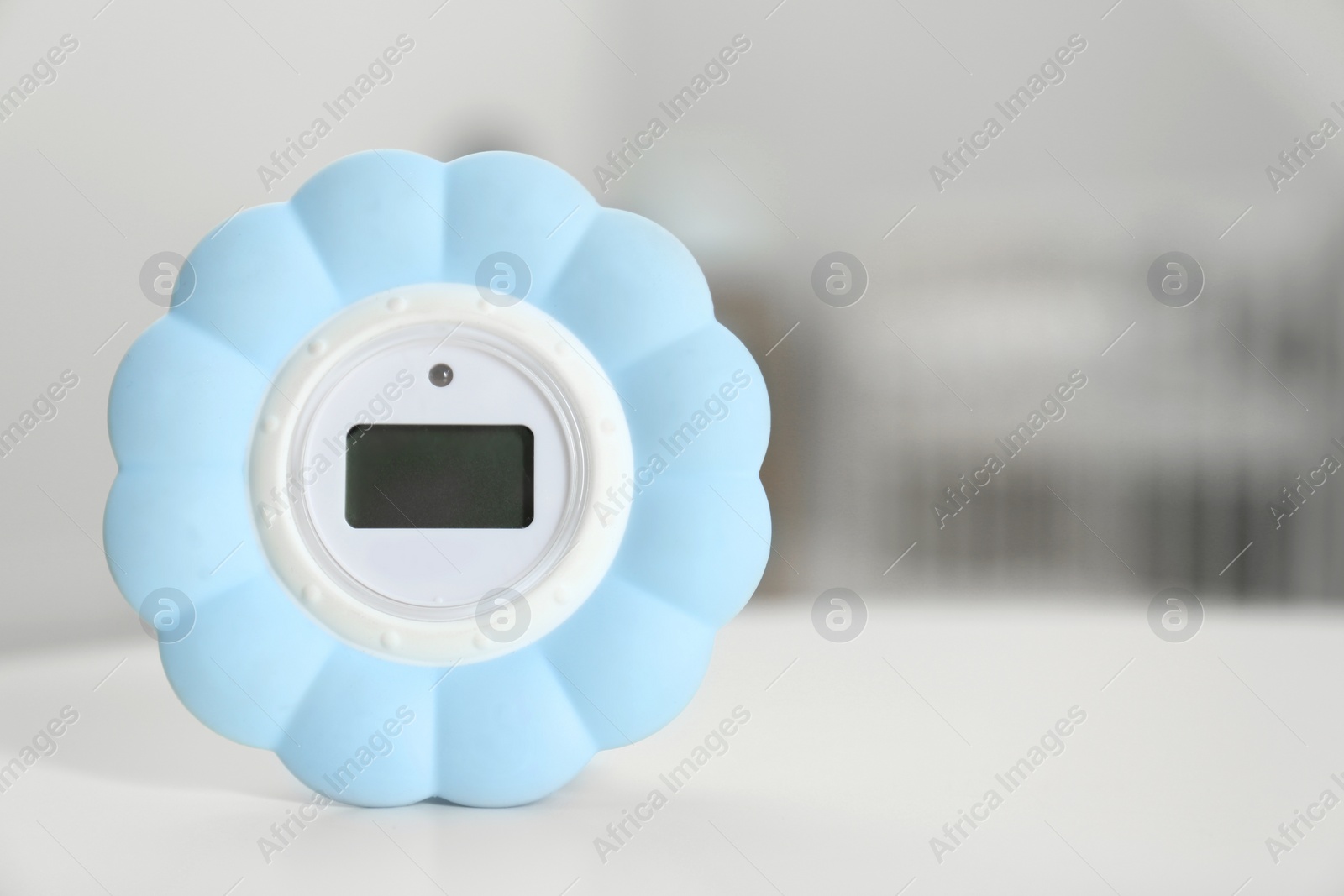 Photo of Digital temperature and humidity control in baby room interior. Space for text