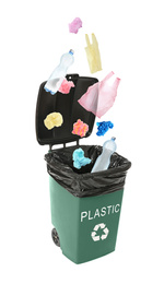 Image of Different plastic garbage falling into trash bin. Waste management and recycling