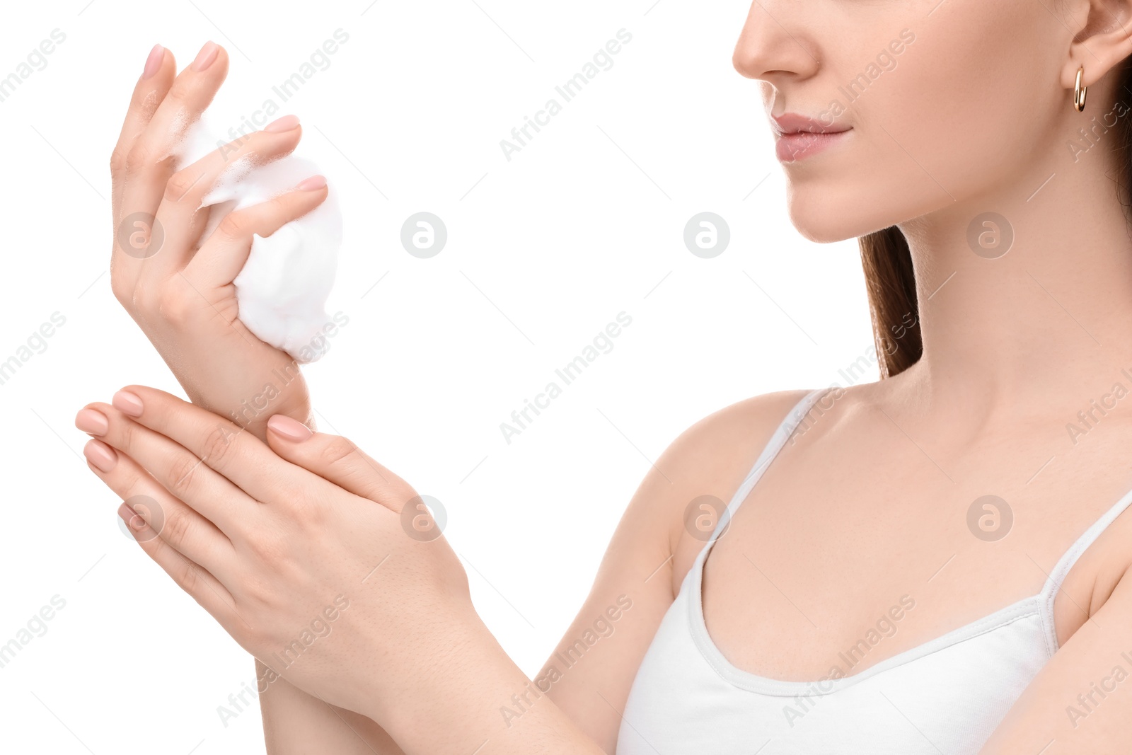 Photo of Woman with cleansing foam on hands against white background, closeup