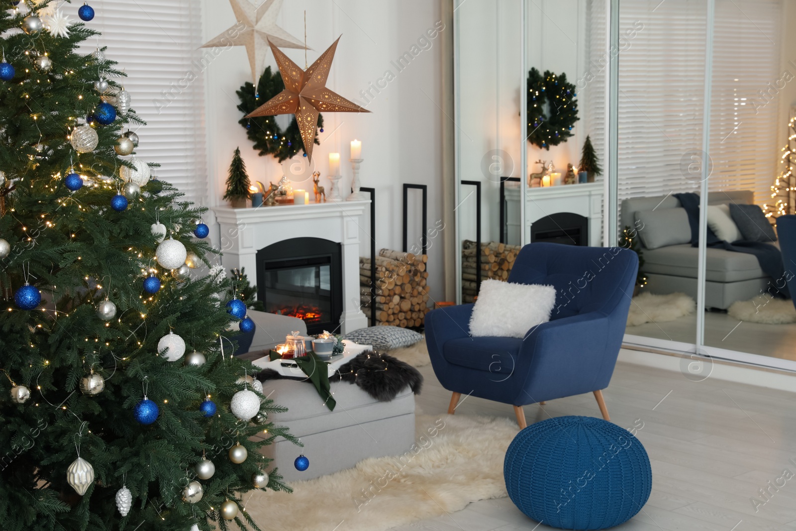 Photo of Cozy living room interior with beautiful Christmas tree and comfortable furniture