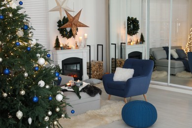 Cozy living room interior with beautiful Christmas tree and comfortable furniture