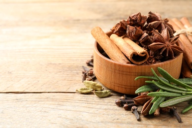 Composition with mulled wine ingredients on wooden table. Space for text