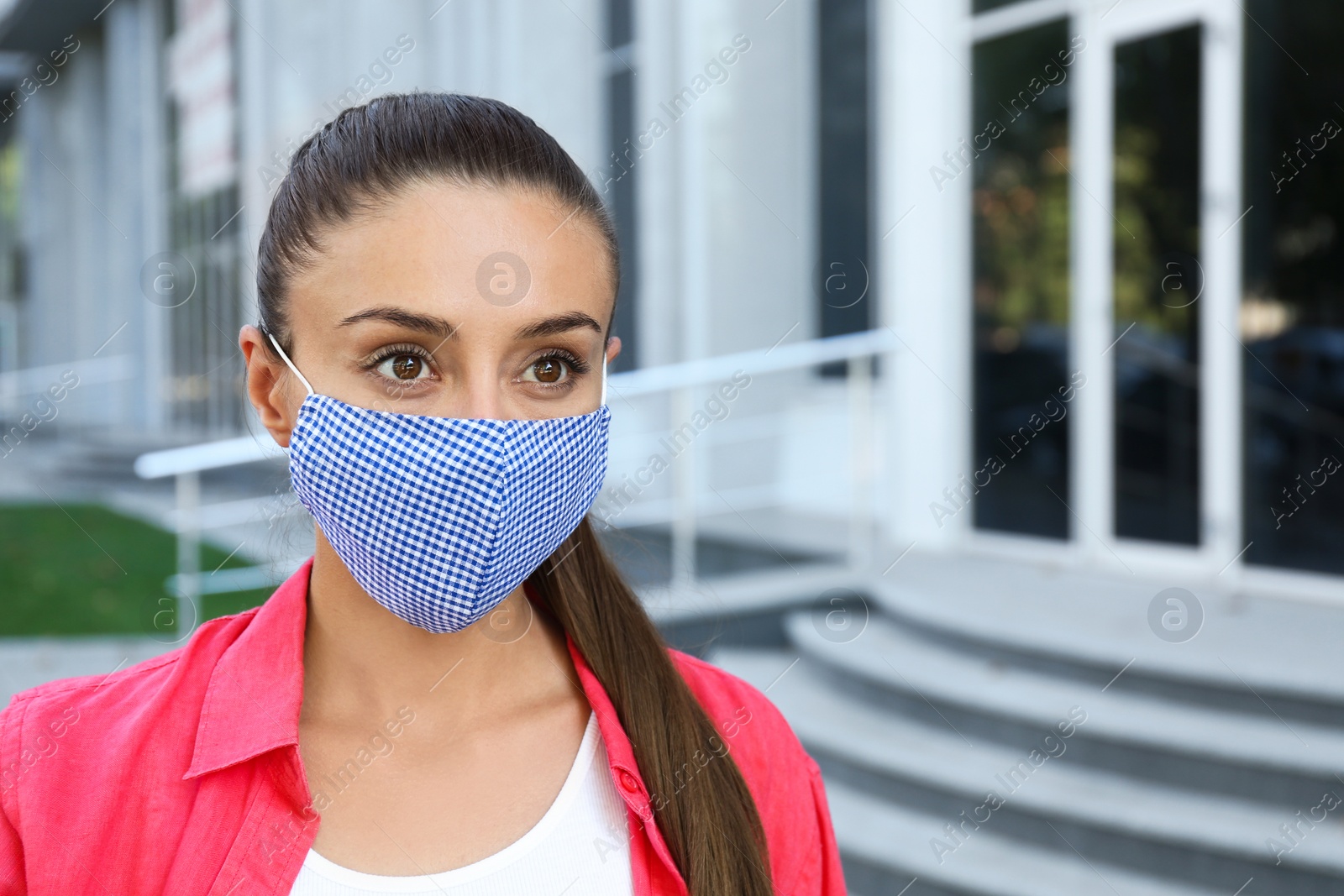 Photo of Woman wearing handmade cloth mask outdoors, space for text. Personal protective equipment during COVID-19 pandemic