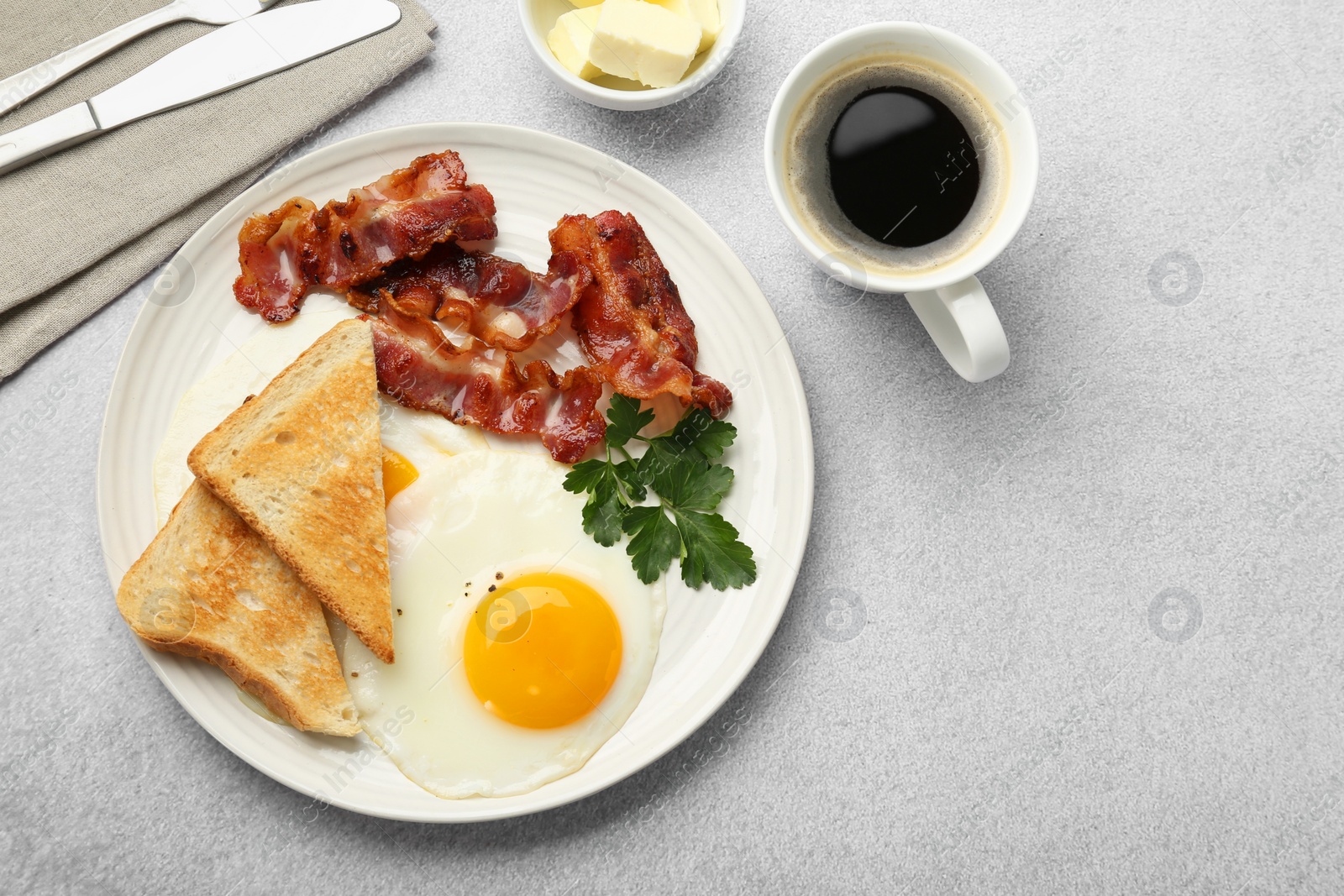 Photo of Delicious breakfast with sunny side up egg served on light table, flat lay. Space for text