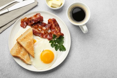 Delicious breakfast with sunny side up egg served on light table, flat lay. Space for text