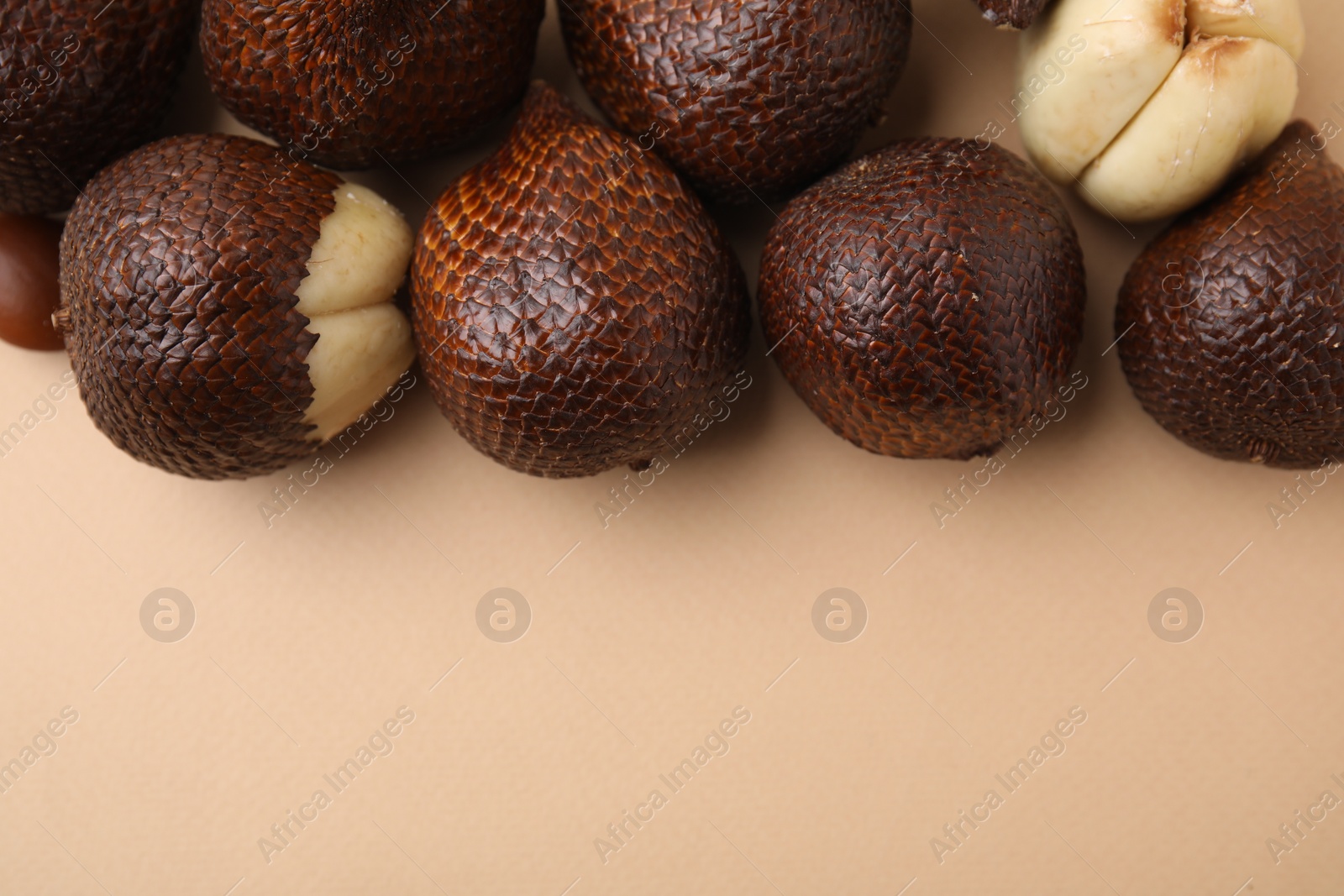 Photo of Fresh salak fruits on beige background, top view. Space for text