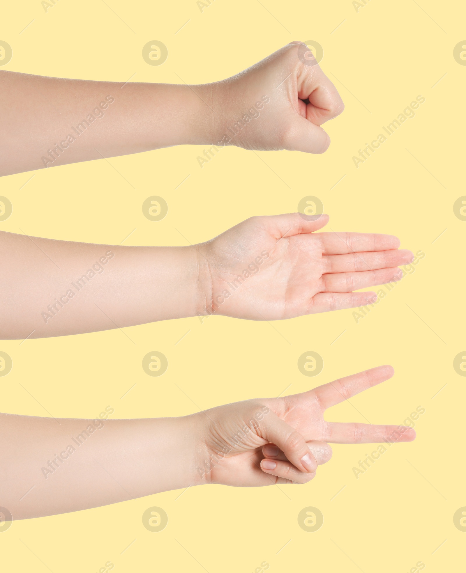 Image of People playing rock, paper and scissors on yellow background, closeup