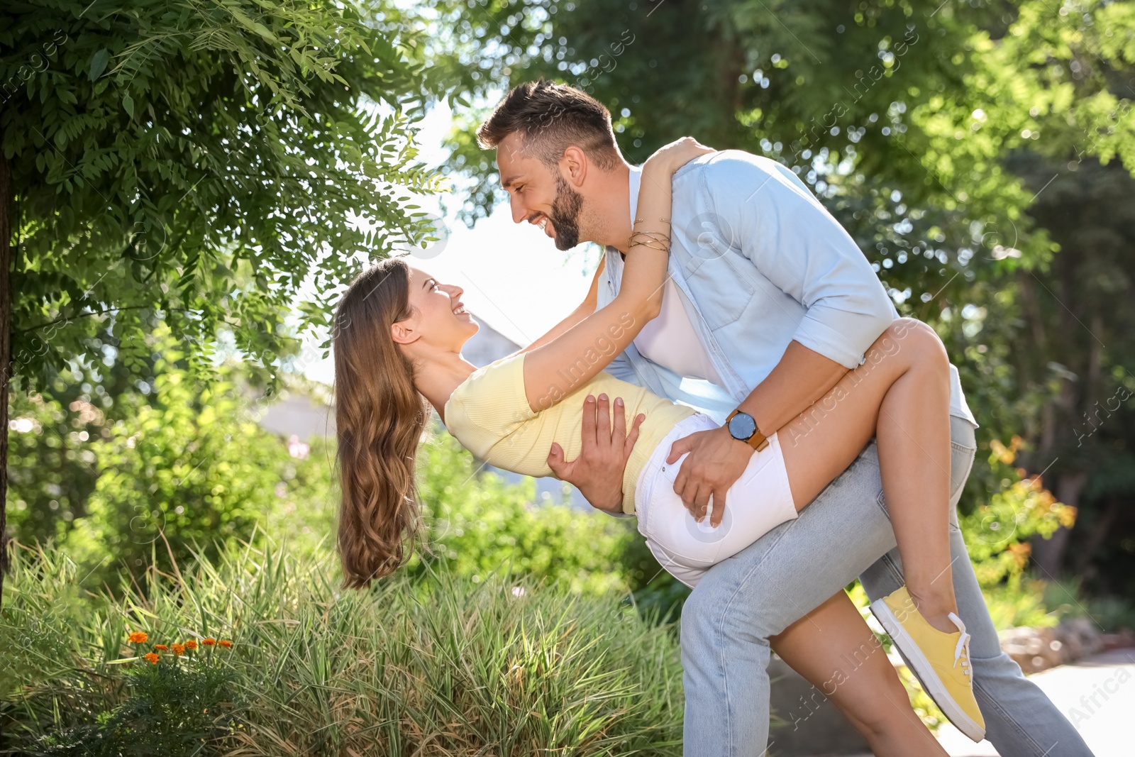 Photo of Lovely young couple dancing together in park on sunny day