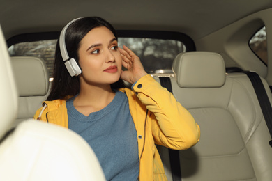 Photo of Young woman listening to audiobook in car