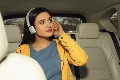 Young woman listening to audiobook in car