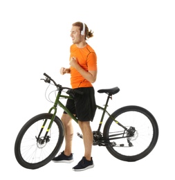 Photo of Young man with headphones dancing near bicycle on white background