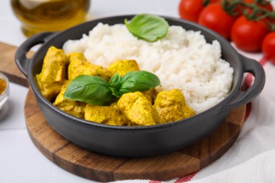 Photo of Delicious rice and chicken with curry sauce on white table, closeup