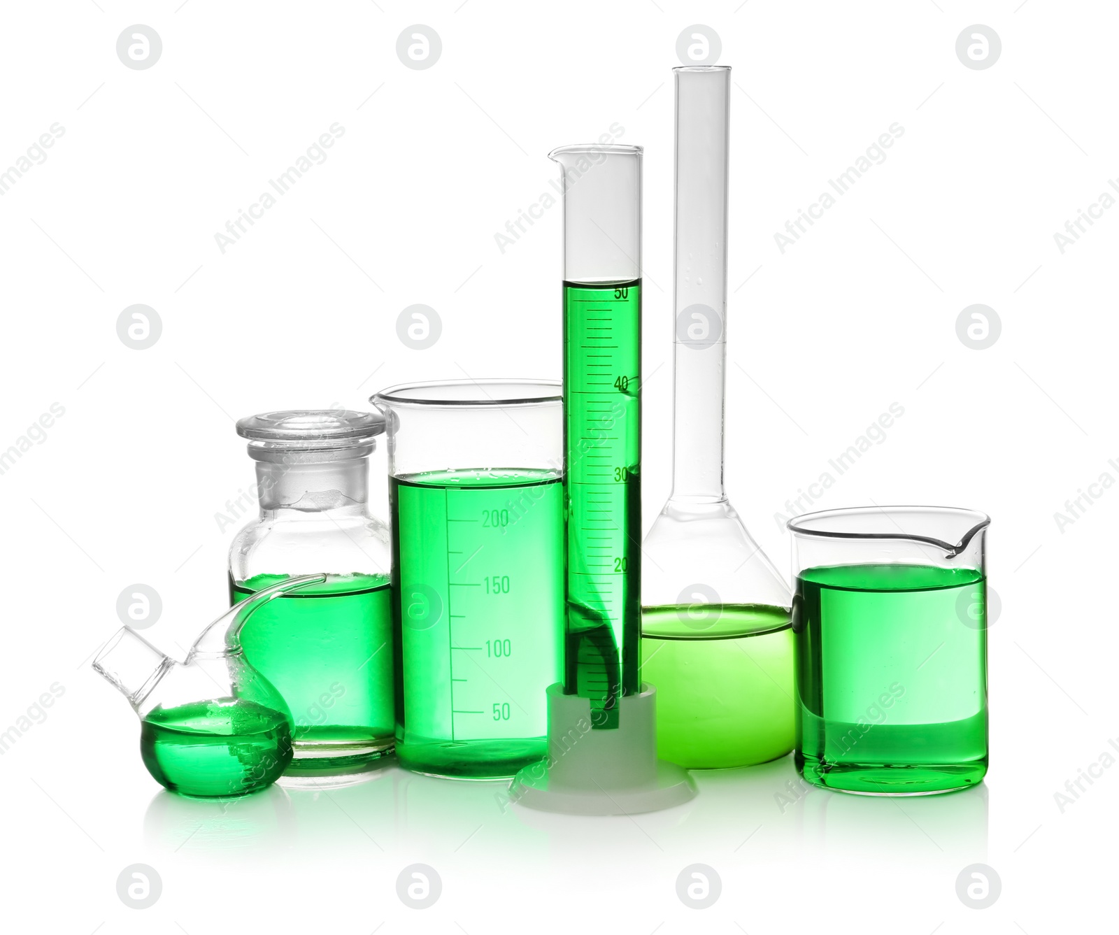 Photo of Laboratory glassware with green liquid on white background