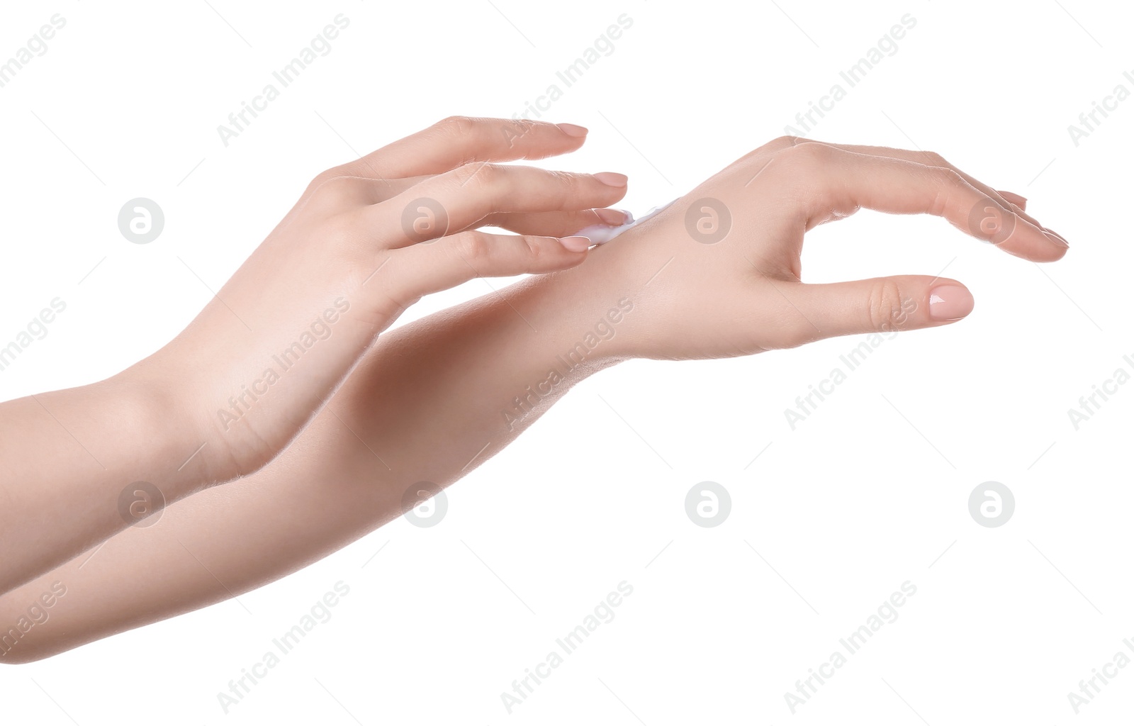 Photo of Woman applying cream on her hand against white background, closeup