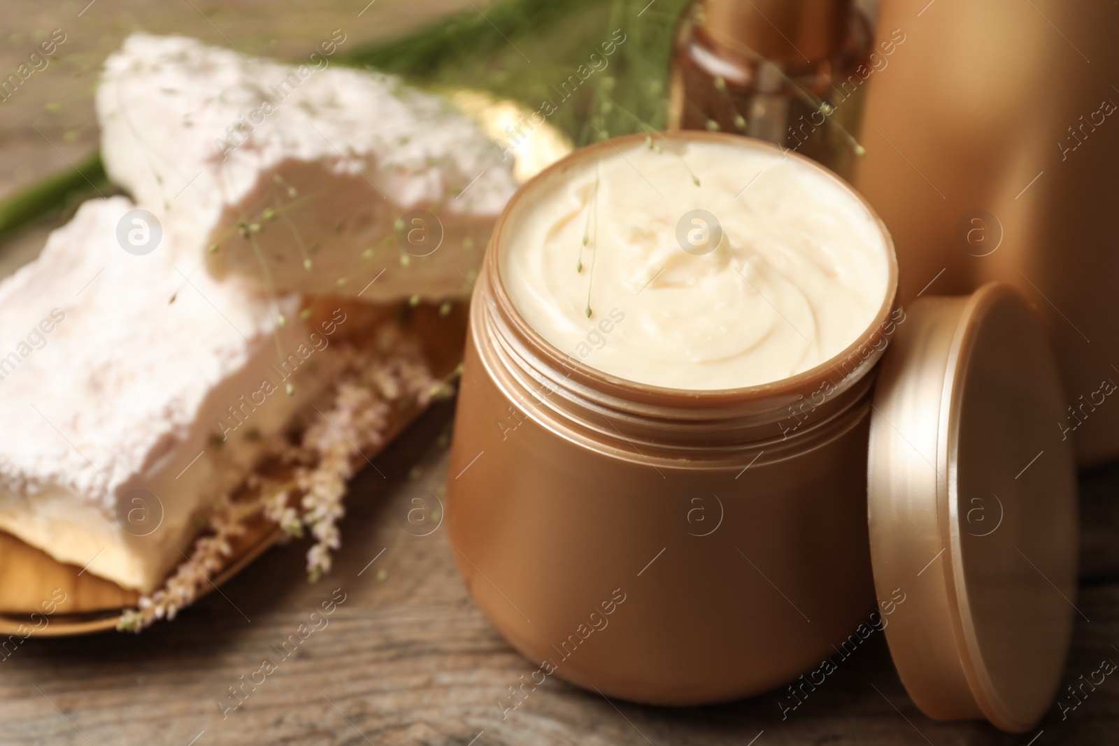 Photo of Hair cosmetic products on wooden table, closeup