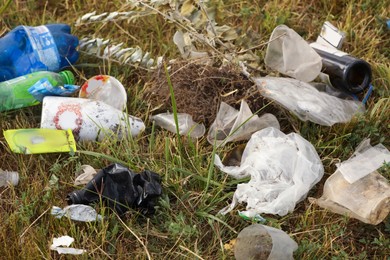 Photo of Garbage scattered on grass. Environment pollution problem