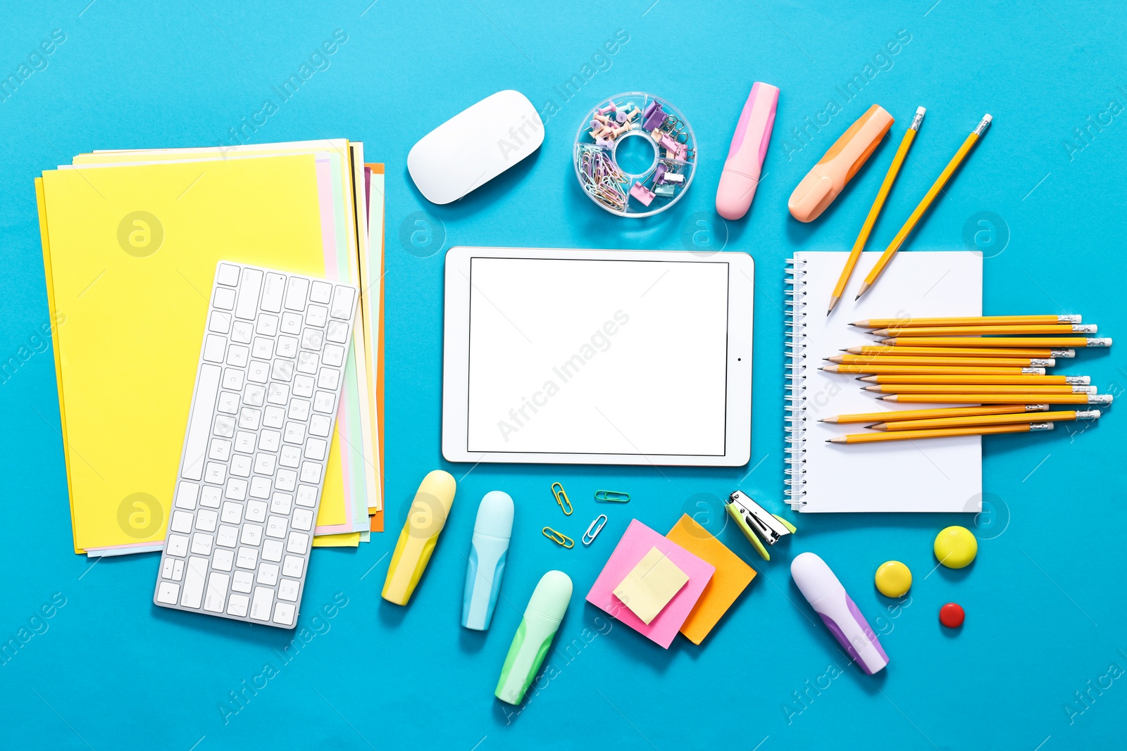 Photo of Modern tablet, keyboard and stationery on light blue background, flat lay. Space for text