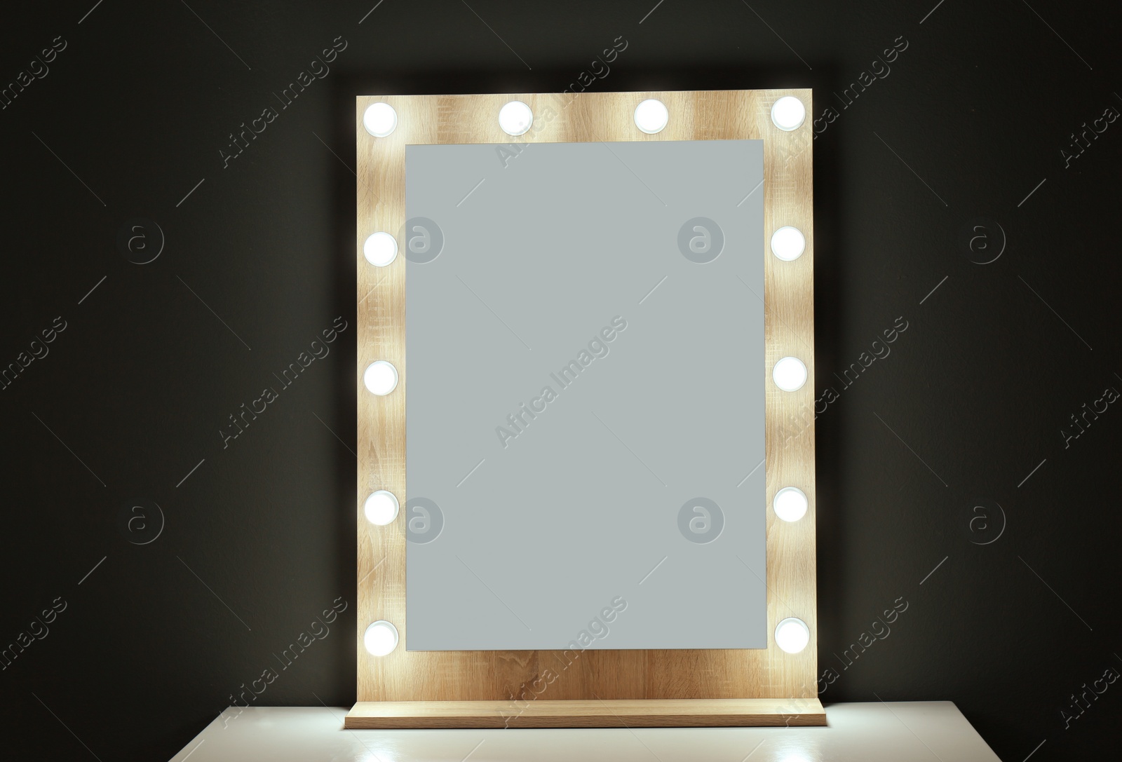 Photo of Table with mirror near color wall. Dressing room interior