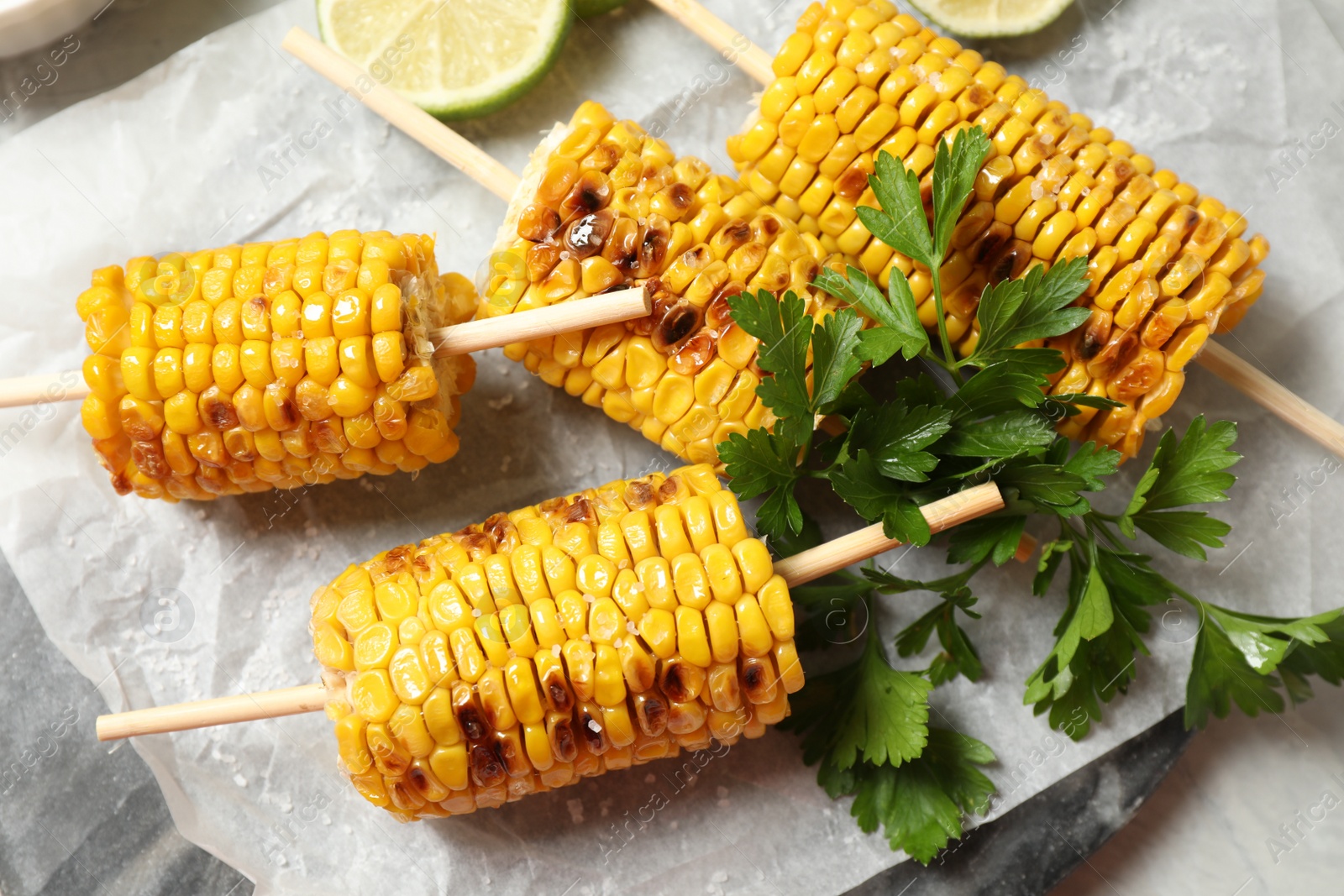 Photo of Composition with tasty grilled corn on table