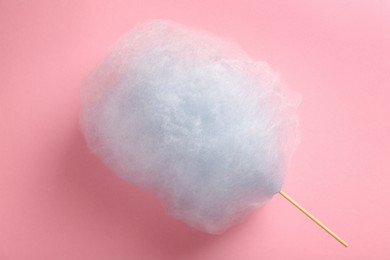 Sweet light blue cotton candy on pink background, top view