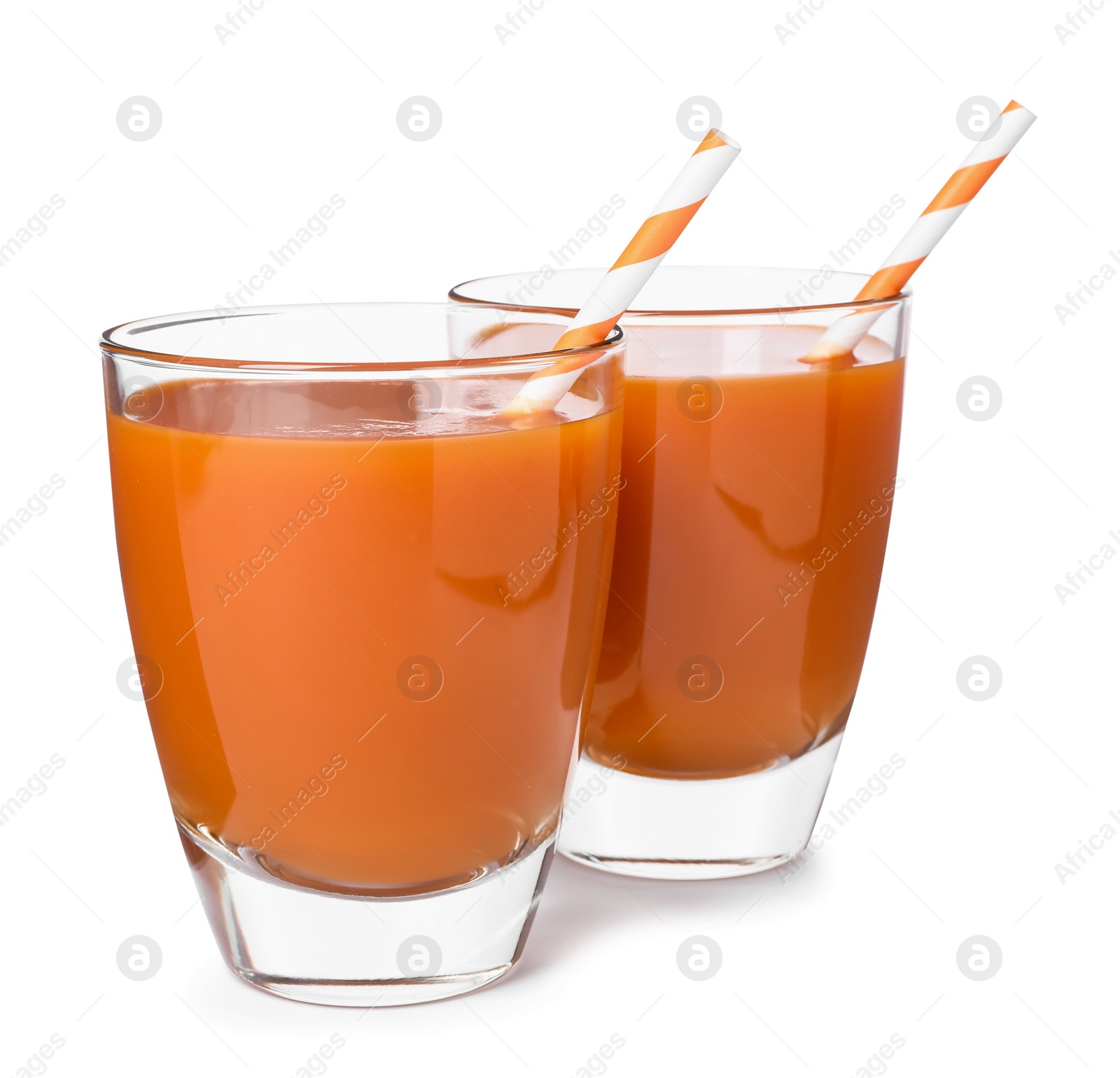 Photo of Two glasses of carrot juice with straws on white background