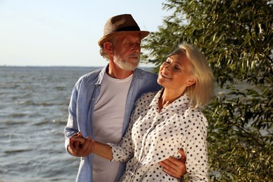 Lovely mature couple spending time together near river