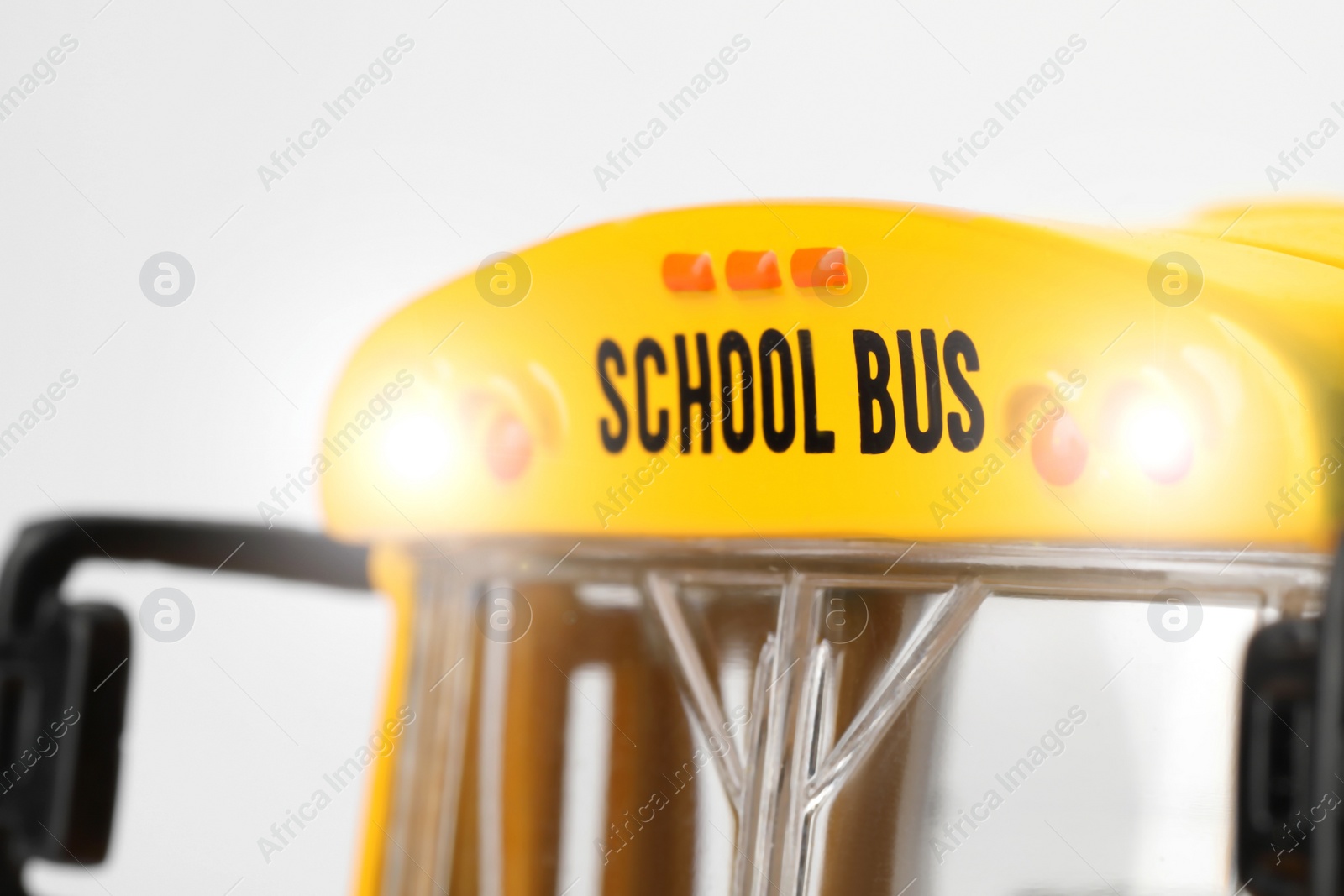 Photo of Yellow school bus on white background, closeup. Transport for students