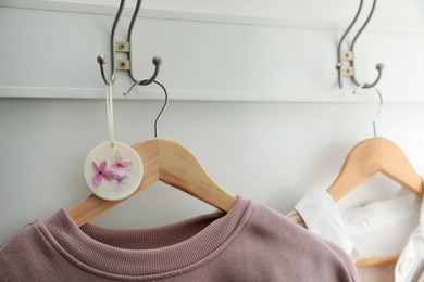 Beautiful scented sachet and stylish clothes on hooks