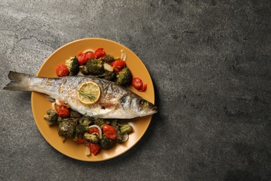 Delicious baked fish and vegetables on grey background, top view. Space for text