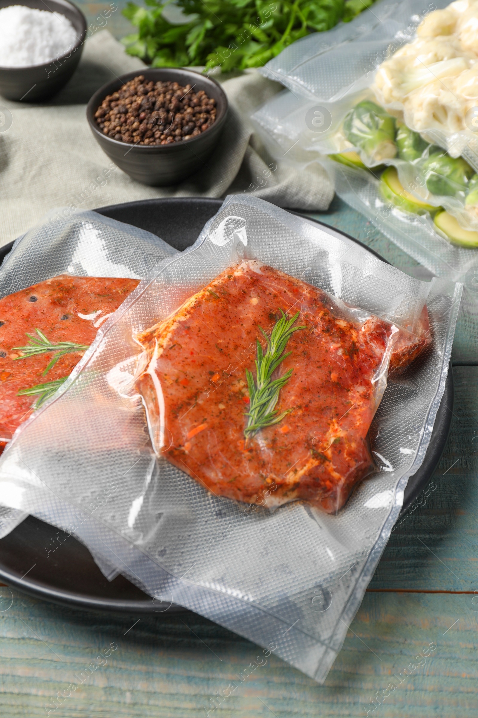 Photo of Meat in vacuum packings on wooden table