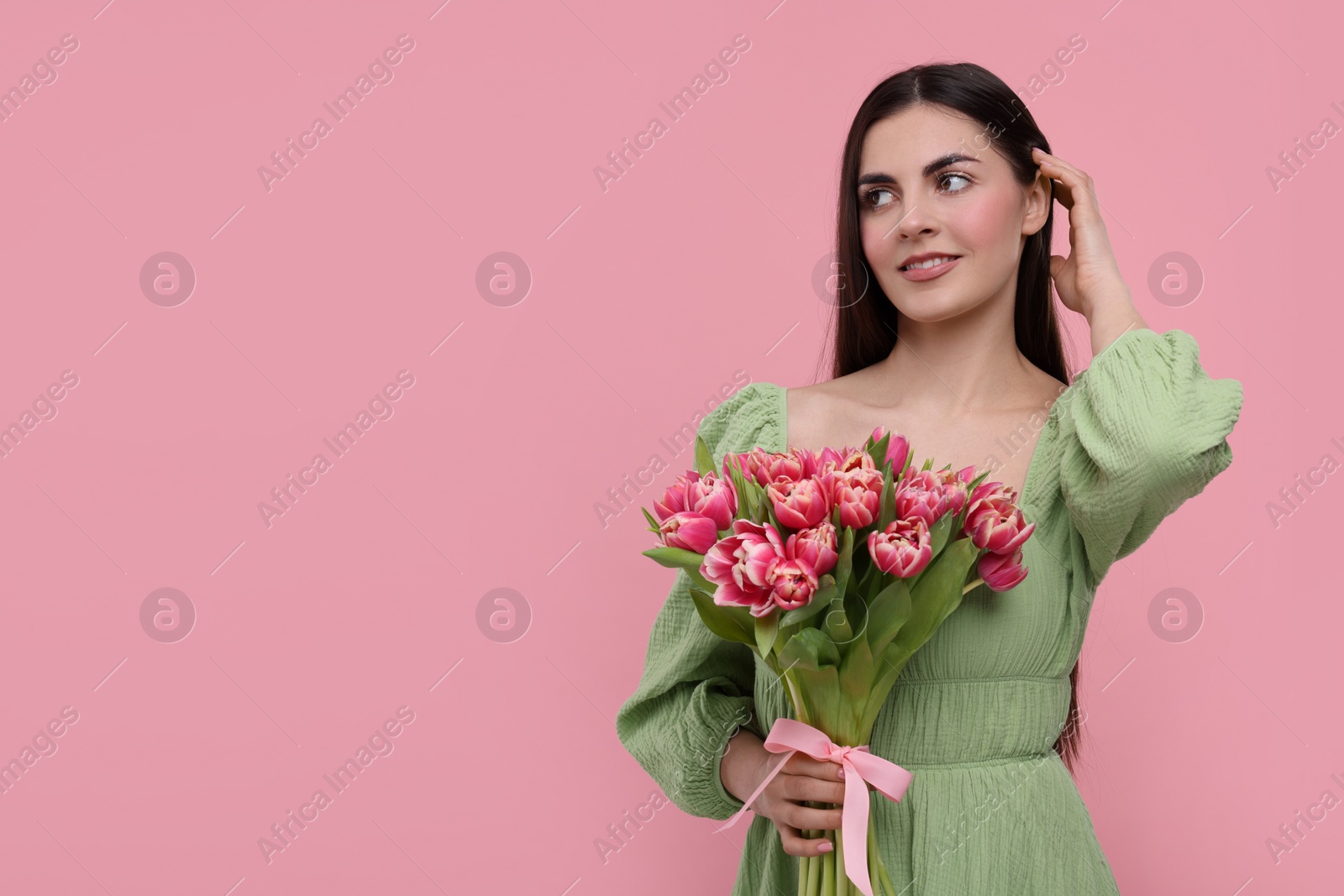 Photo of Happy young woman with beautiful bouquet on dusty pink background. Space for text