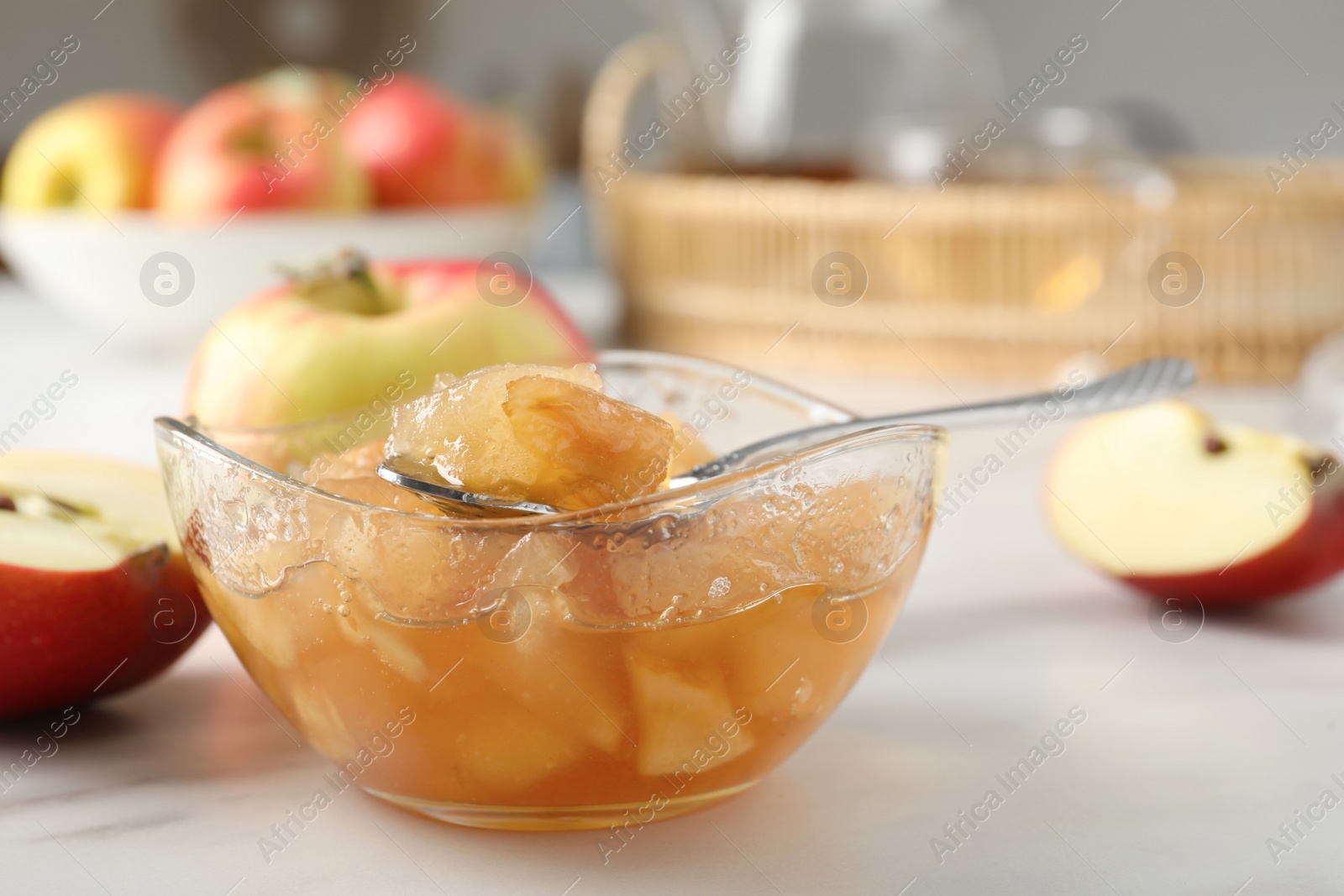 Photo of Delicious apple jam and fresh fruits on white table, closeup